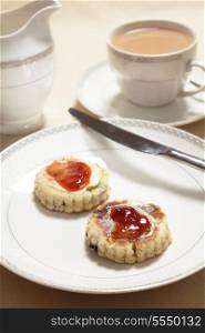 An afternoon tea served with Welsh cakes, topped with butter and jam