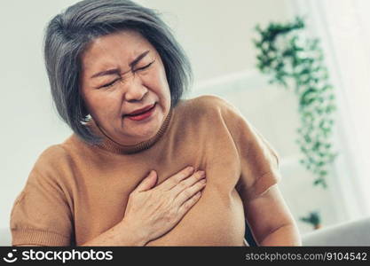 An agonizing elderly woman is experiencing chest pain. Medical attention, senior care service.. An agonizing elderly woman is experiencing chest pain.