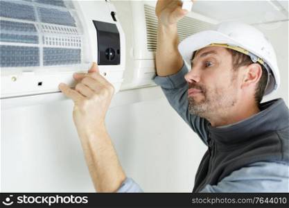an air conditioning technician at work