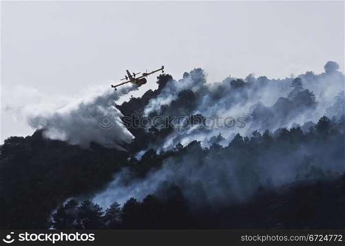 An aircraft firefighter in Spain against forest fires, canadair 415, Model CL415, throw water to extinguish