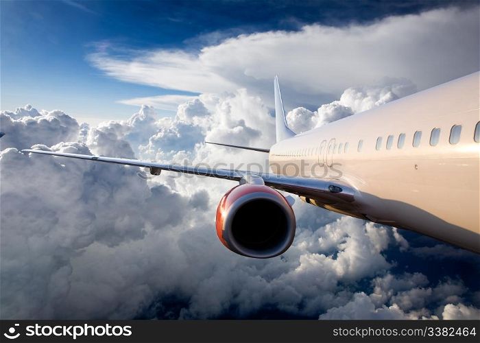 An airplane flying over a dramatic sky