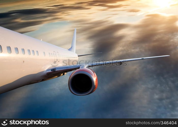 An airplane flying over a dramatic sky