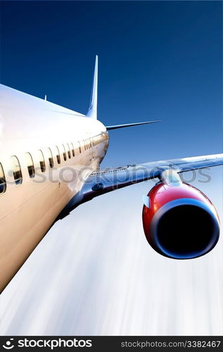 An airplane in flight over a blue sky