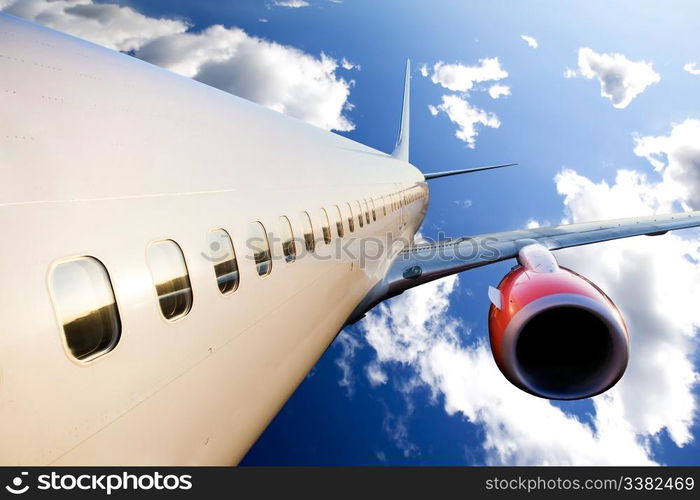 An airplane in flight over a blue sky