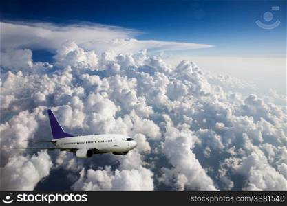 An airplane in flight over clouds