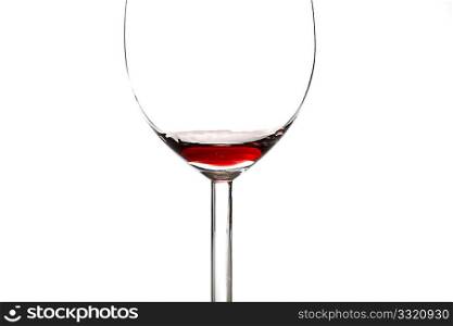 An almost empty red wine glass