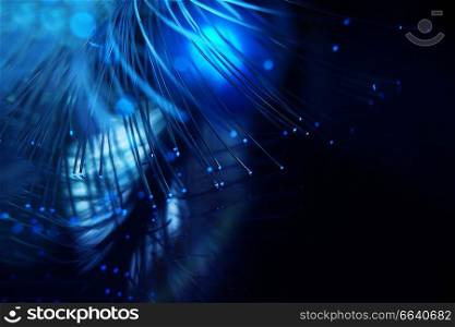 An amazing and vibrant macro of blue fiber optical pipes that illuminate making sparkles and glitters with black background