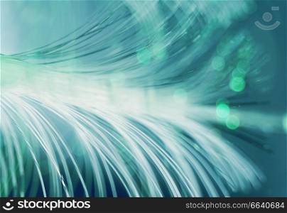 An amazing and vibrant macro of green fiber optical pipes that illuminate making sparkles and glitters with black background