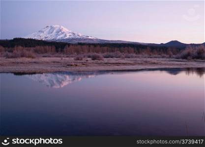An amazing still lake scene in front of Mount Adams Washington