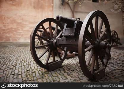 An ancient cannon / exhibition of an antique historical cannon in an old castle, a vintage weapon