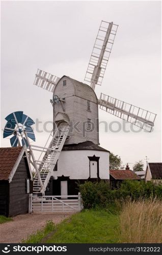 An ancient post mill in the English countryside