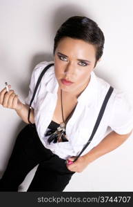 An androgynous person smokes a cigarette