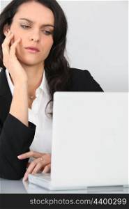 An angry businesswoman staring at her laptop