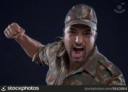 An angry young soldier shouting over black background