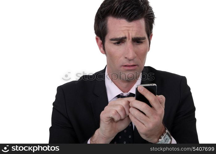 An anxious man texting.