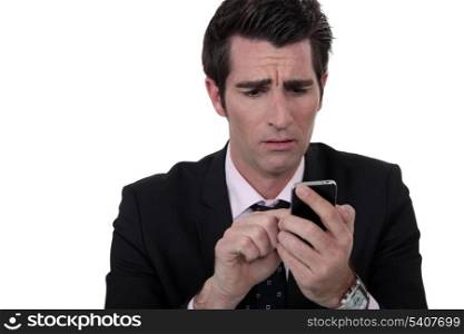 An anxious man texting.