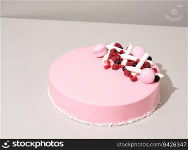 An appetizing pink cake with white strawberries adorning the top sits invitingly on a table. Appetizing pink cake with white strawberries adorning the top sits invitingly on a table