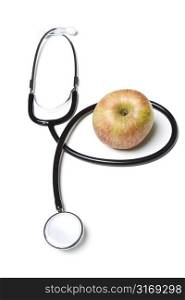 An apple and a stethoscope, can be used for medical or healthcare concept
