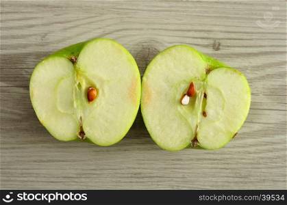 An apple that is sliced in two halves