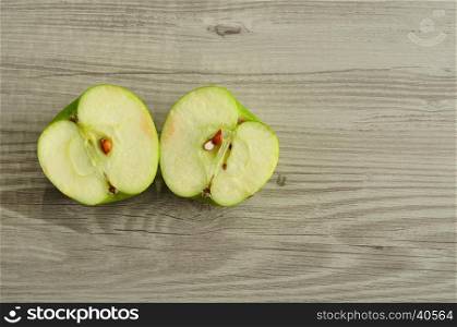 An apple that is sliced in two halves