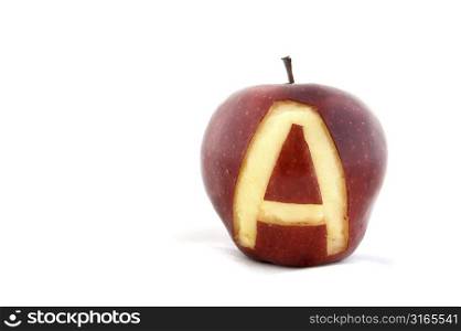 An apple with the letter A carved out of the skin