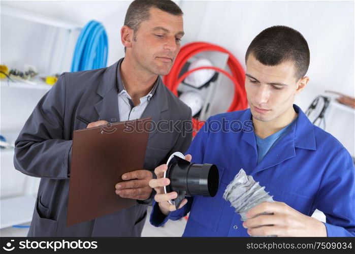 an apprentice checking ventilation pipe