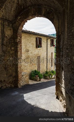 An arched passage in the old town in Italy