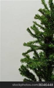 An artificial Christmas tree with no decorations isolated against a white background