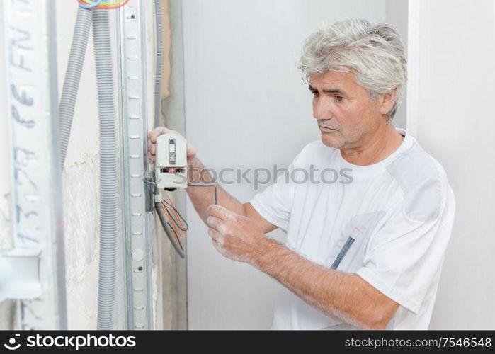 an artisan checking house wiring