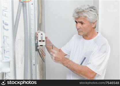an artisan checking house wiring