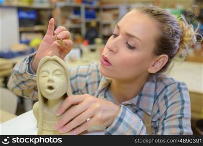 an artist blowing a statue
