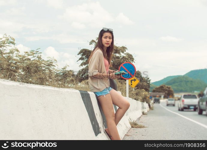 An asian beautiful woman get lost and reading map while traveling in summer time.