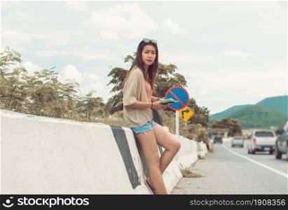 An asian beautiful woman get lost and reading map while traveling in summer time.