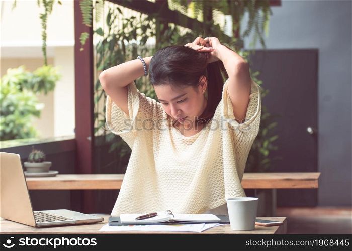 An asian beautiful woman is relaxing and using laptop for planning jobs and working at home