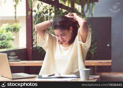 An asian beautiful woman is relaxing and using laptop for planning jobs and working at home