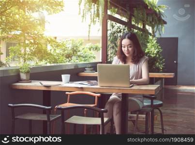An asian beautiful woman is using laptop for planning jobs and working at home