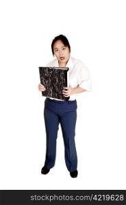 An Asian business woman holding a organizer in her hand, standingin blue dress pants for white background.