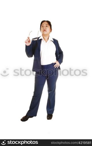 An Asian business woman holding her grasses in her hand, looking upand thinking about the decision she has to make, over white.