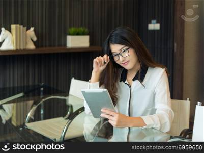 An asian business woman using a tablet