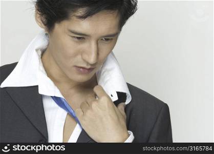 An asian businessman gets ready to relax after work