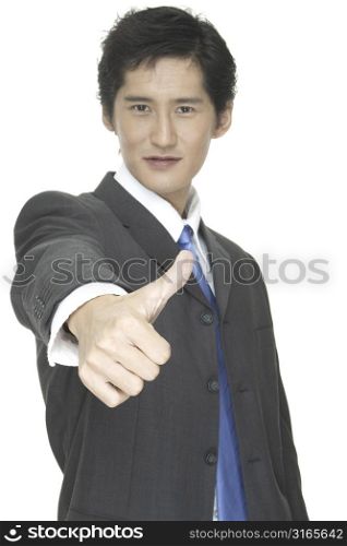 An asian businessman gives the thumbs up