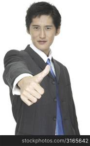 An asian businessman gives the thumbs up