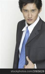 An asian businessman in grey suit