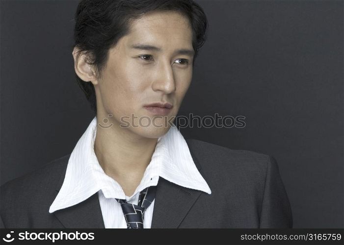 An asian businessman in grey suit and white shirt