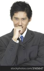 An asian businessman in grey suit with blue tie