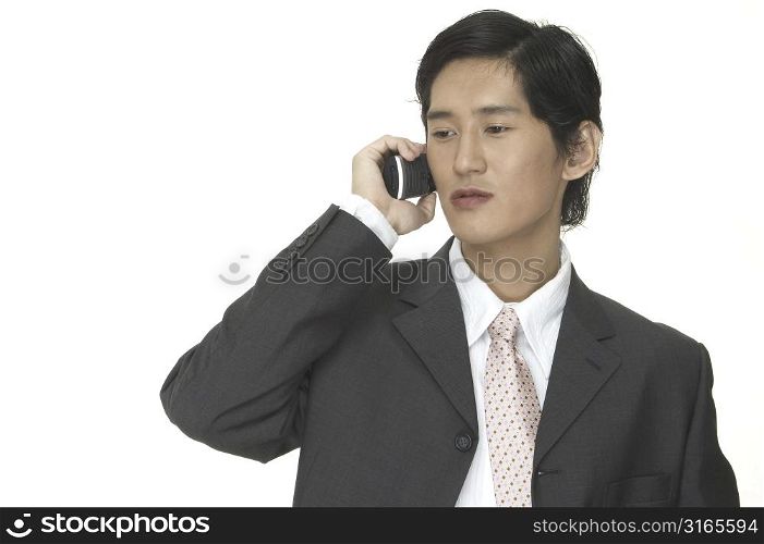 An asian businessman makes an important business phone call