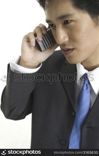An asian businessman talks business on the phone