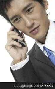 An asian businessman talks on the phone