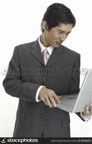 An asian businessman using a laptop computer