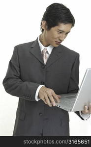 An asian businessman using a laptop computer